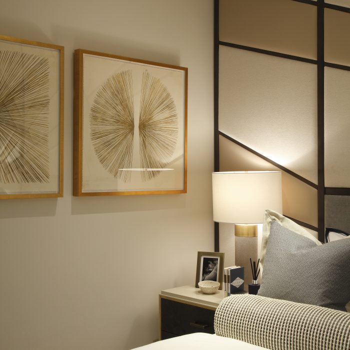 A bedroom corner detail with modern art picures