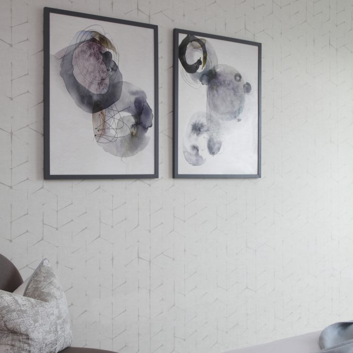 Grey watercolour pictures on a white wall