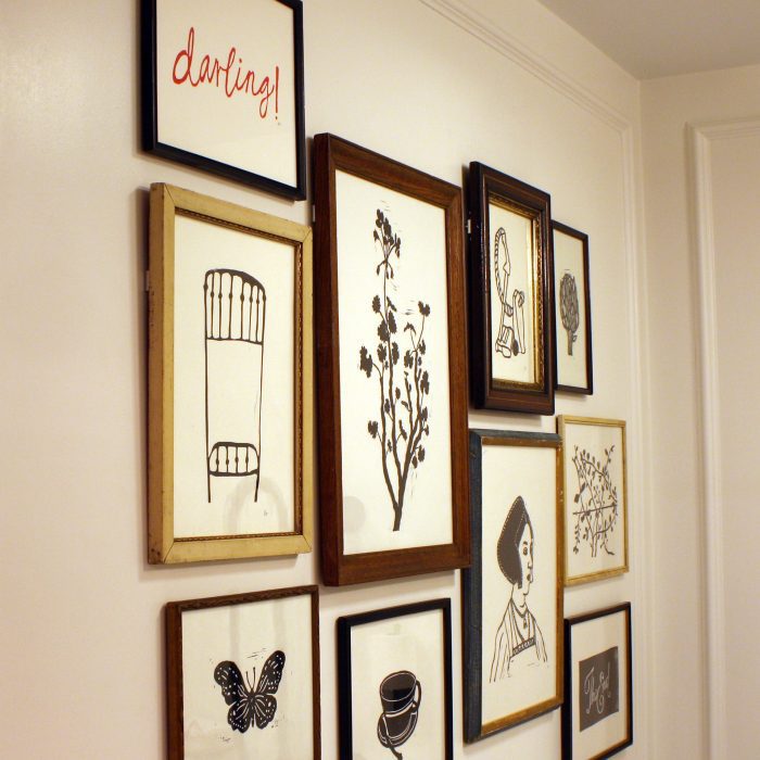 Several framed drawings on the wall