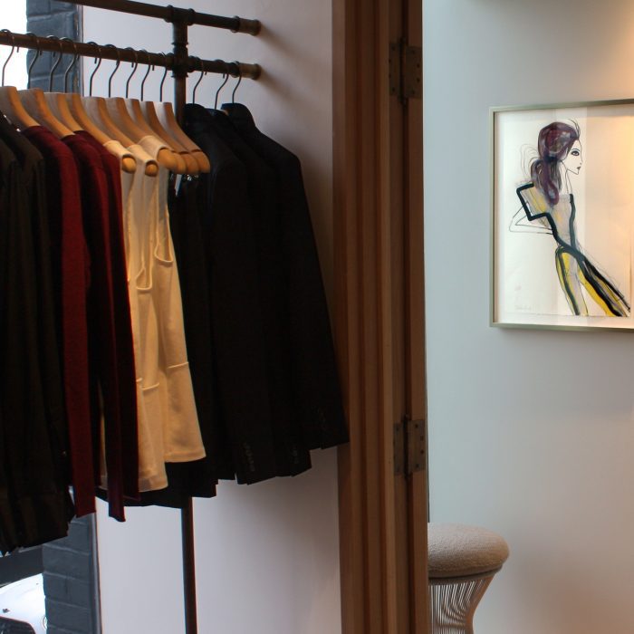 Hangers with clothes and a drawing of a model