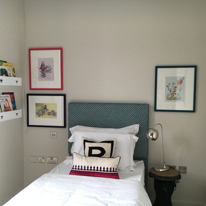 Childrens bedroom with cartoon motive pictures on the wall