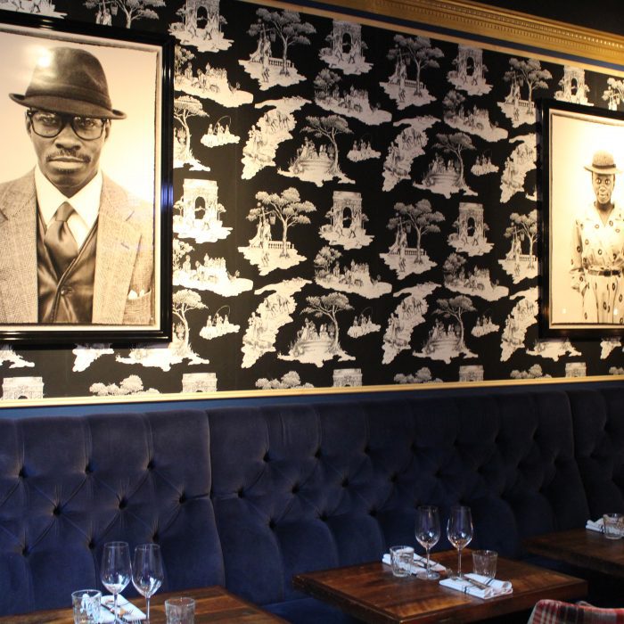 A restaurant, b/w wallpaper and 2 photos above blue sofa