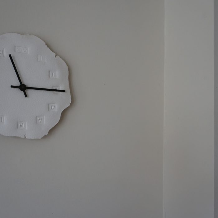 A white clock on a wall