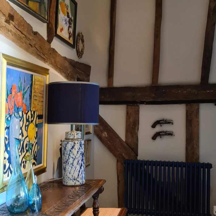 A room corner with paintings and a lamp