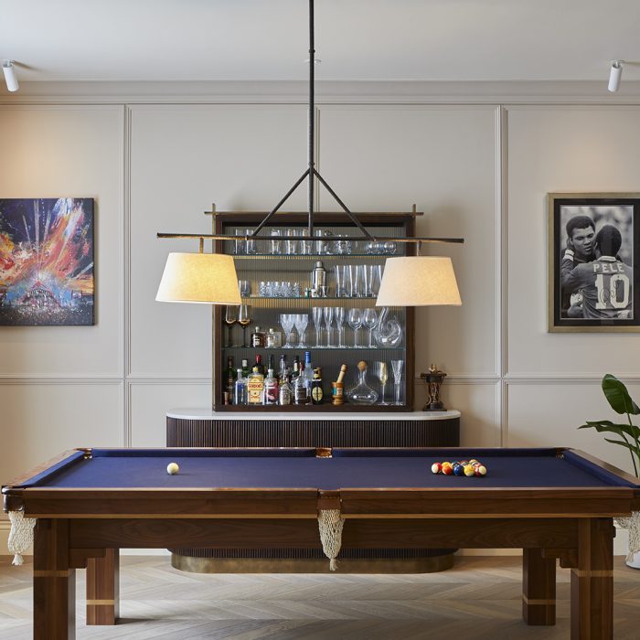 A pool table and a sideboard at the back
