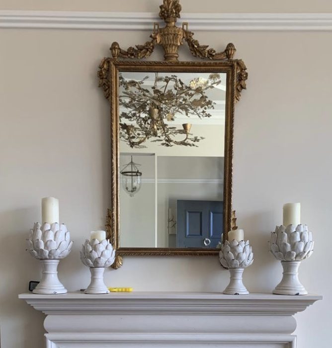 A mirror above a fireplace