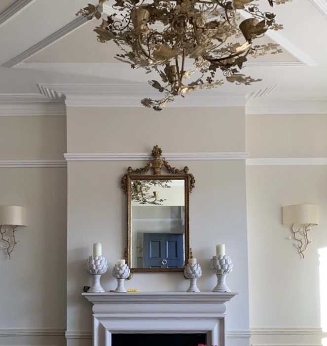 A mirror above a fireplace
